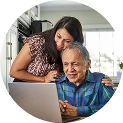 Woman in blue sweater smiling while talking into a headset 